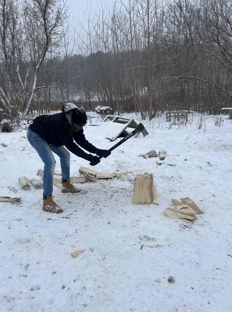 Emmanuel chopping wood